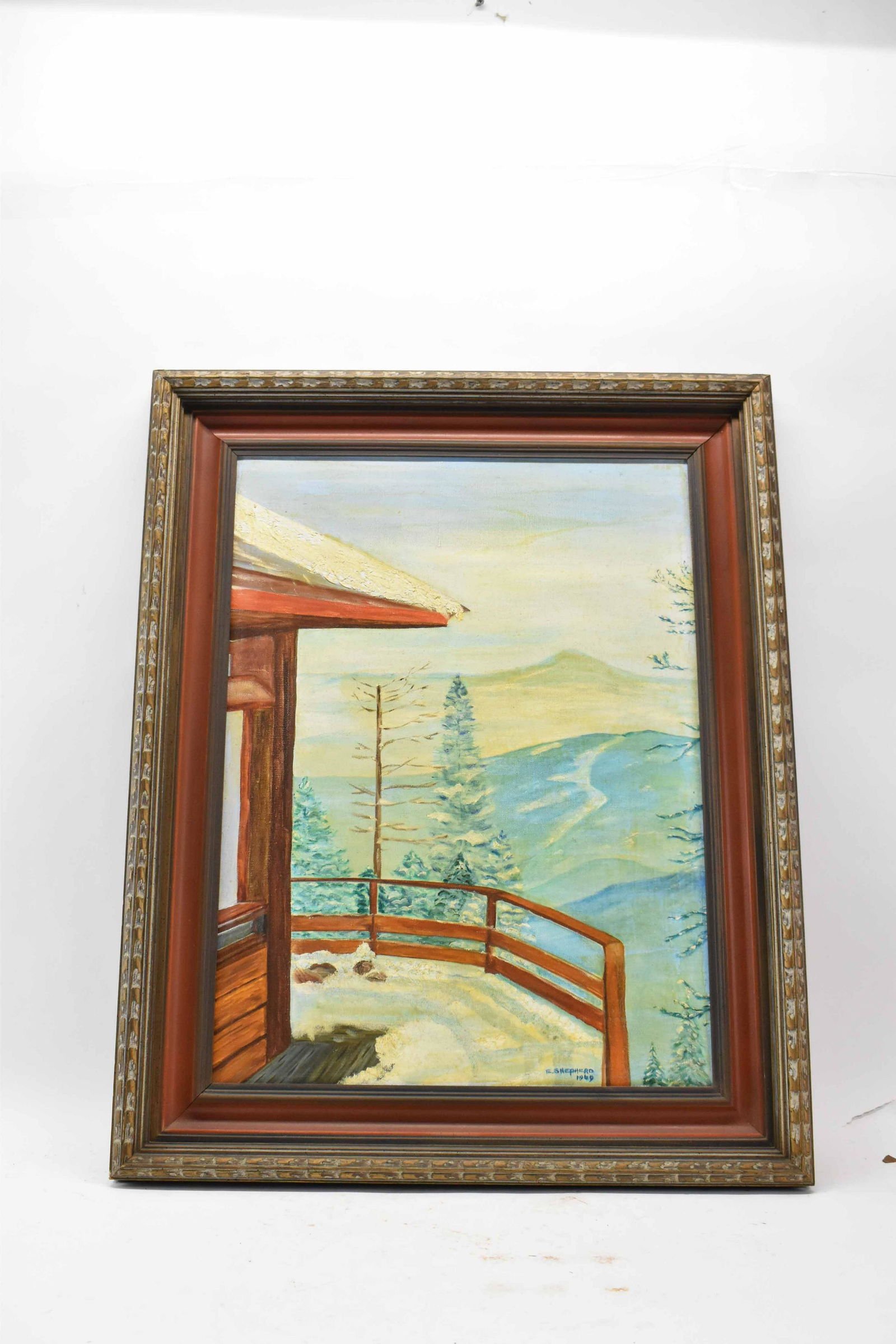 Painting on Canvas of Winter Mountain Scene: Painting on Canvas of Winter Mountain Scene depicting view of mountains from balcony. Signed E. Shepherd 69. Used condition, wear, worn. Frame 30" x 24"