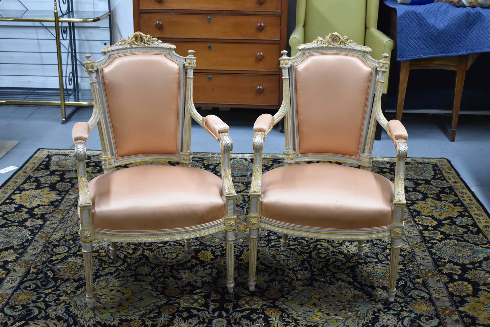 Pair of Louis XVI Style Upholstered Armchairs: Pair of Louis XVI Style Upholstered Arm Chairs having acanthus carvings and gilt decoration; used condition, wear/worn, upholstery tears, measures 38" high x 23 1/2" wide x 24" deep (17 1/2" high to t