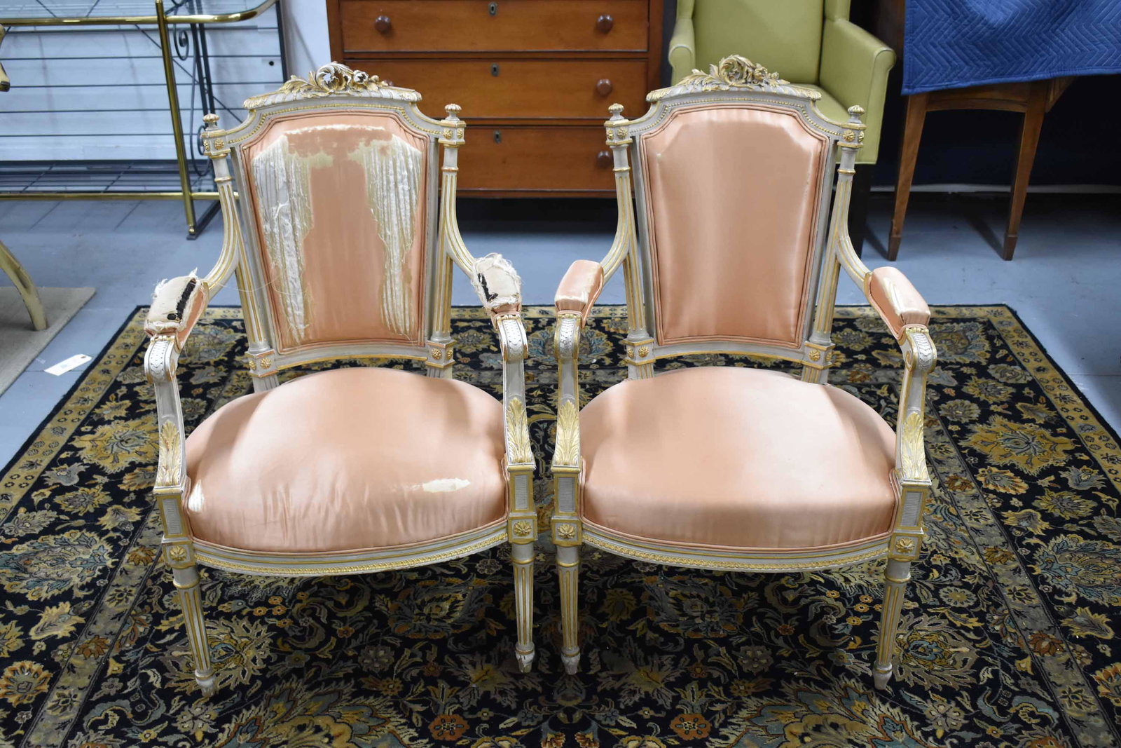 Pair of Louis XVI Style Upholstered Armchairs: Pair of Louis XVI Style Upholstered Arm Chairs having acanthus carvings and gilt decoration; used condition, wear/worn, upholstery tears, measures 38" high x 23 1/2" wide x 24" deep (17 1/2" high to t