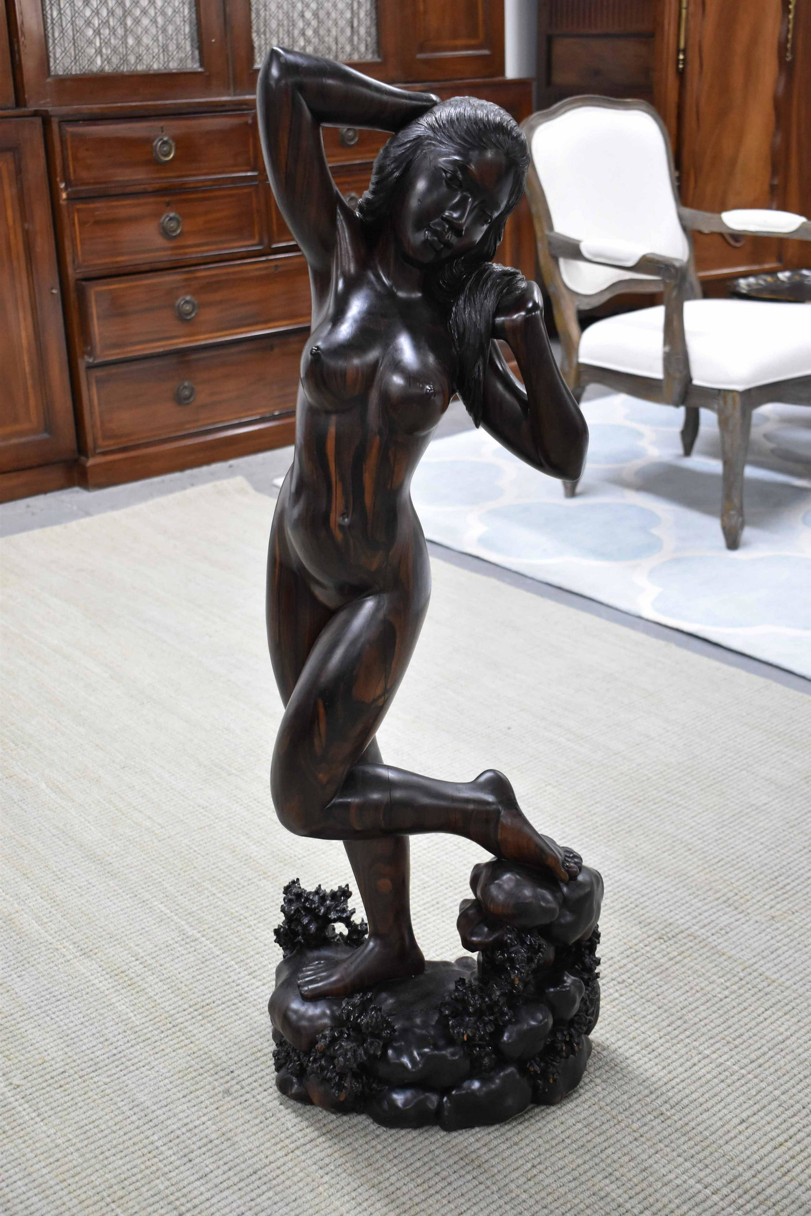 Hand Carved Rosewood Sculpture of Nude Signed: Large Hand Carved Rosewood Sculpture of Nude depicting Balinese woman standing on rocks, signed Ida Bagus Agung Bali; used condition, wear/worn, wood splits, nicks, measures 44 1/4" high x 15 1/2" wid