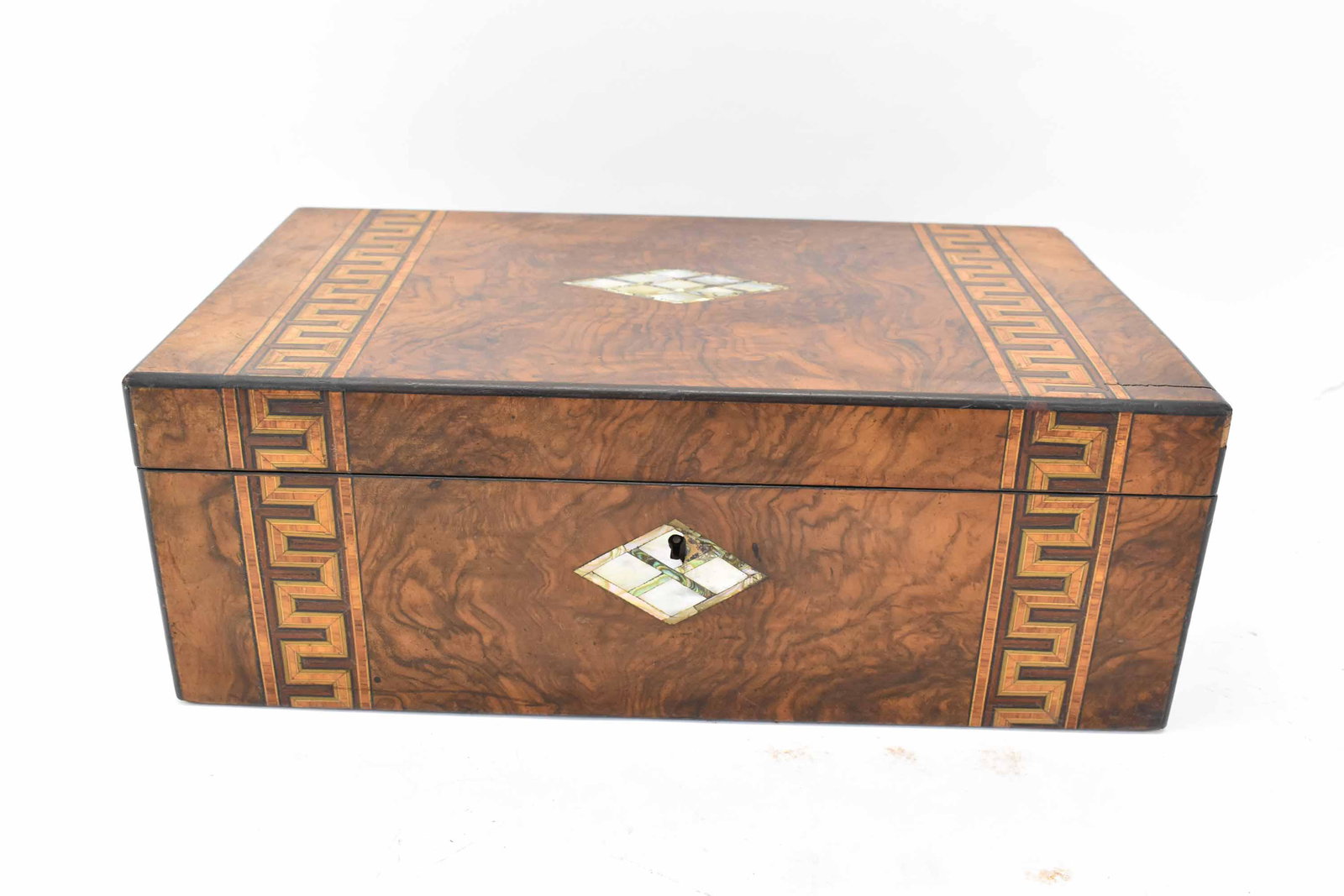 Burlwood and Parquetry Lap Desk: Burlwood and Parquetry Lap Desk having a mother-of-pearl center medallion within a Greek key pattern; used condition; wear/worn, missing pieces and key, splits to wood, chips to corners, measures 15 3