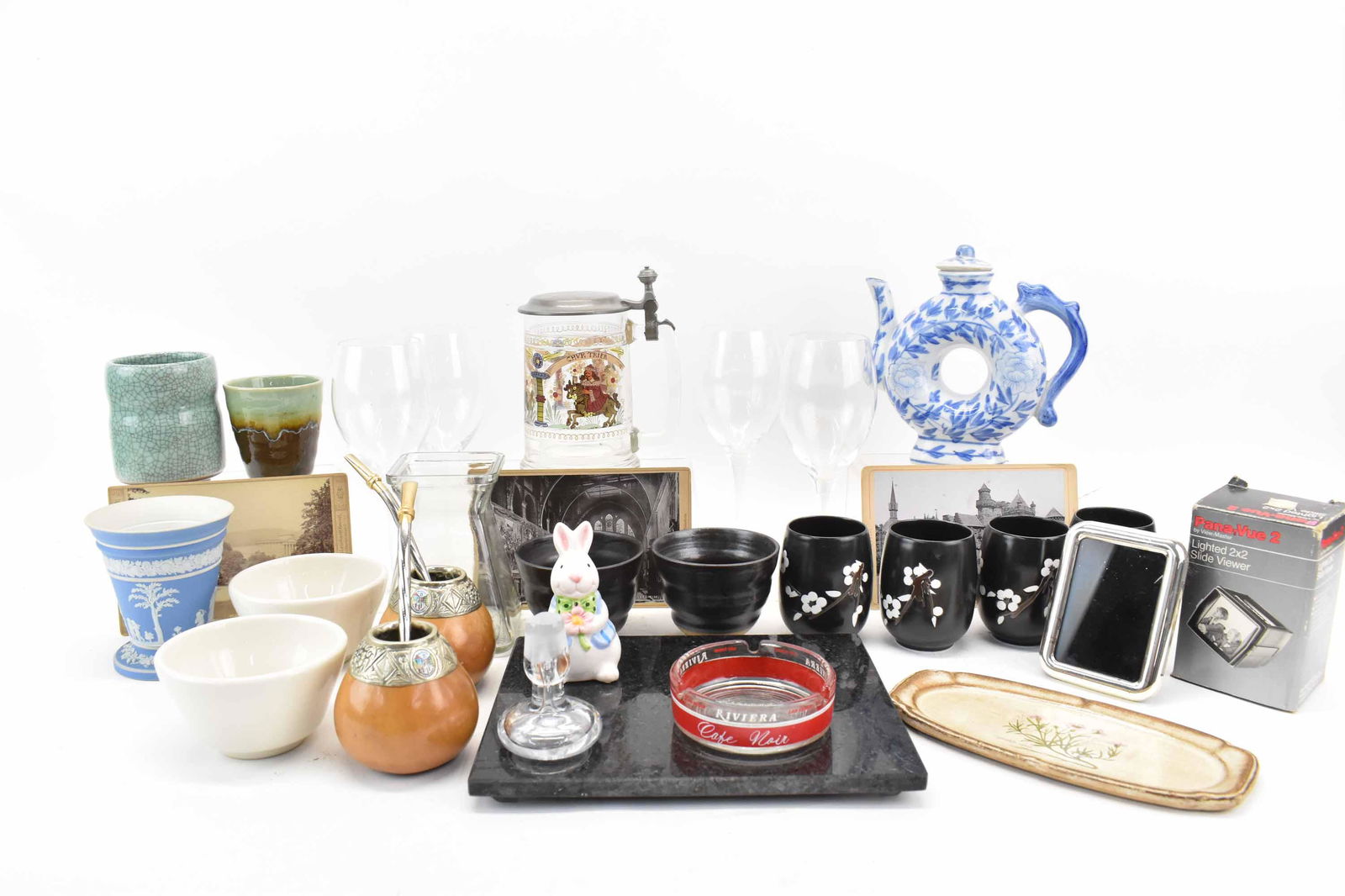Group of Assorted Table Articles: Group of Assorted Table Articles including two Yerba Mate Gourds, a Rein Zinn German Glass Stein, Vintage German Photos, Wine Glasses, Blue & White Chinese Teapot, Granite Trivet, Pana-Vue Lighted 2x2