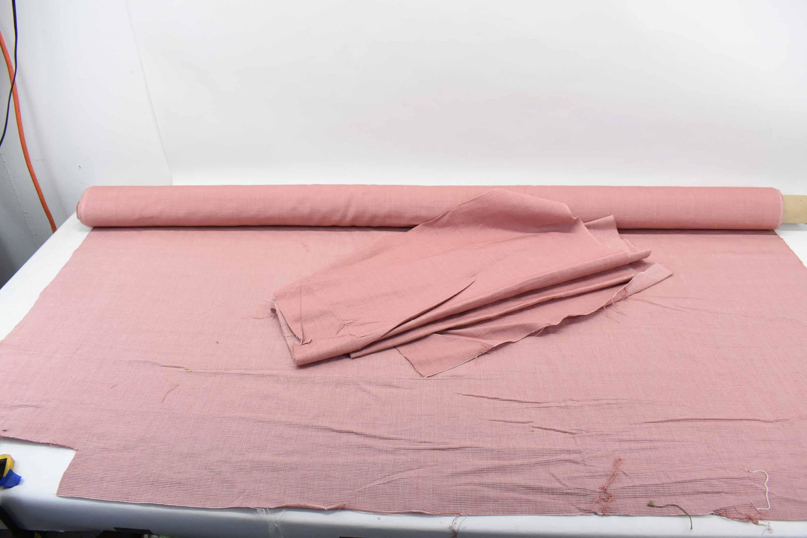 Travers Rose Colored Textured Woven Fabric: Travers Rose Colored Woven Fabric having ribbed design; measures 4 yards long x 54 1/4" wide plus a few remnants