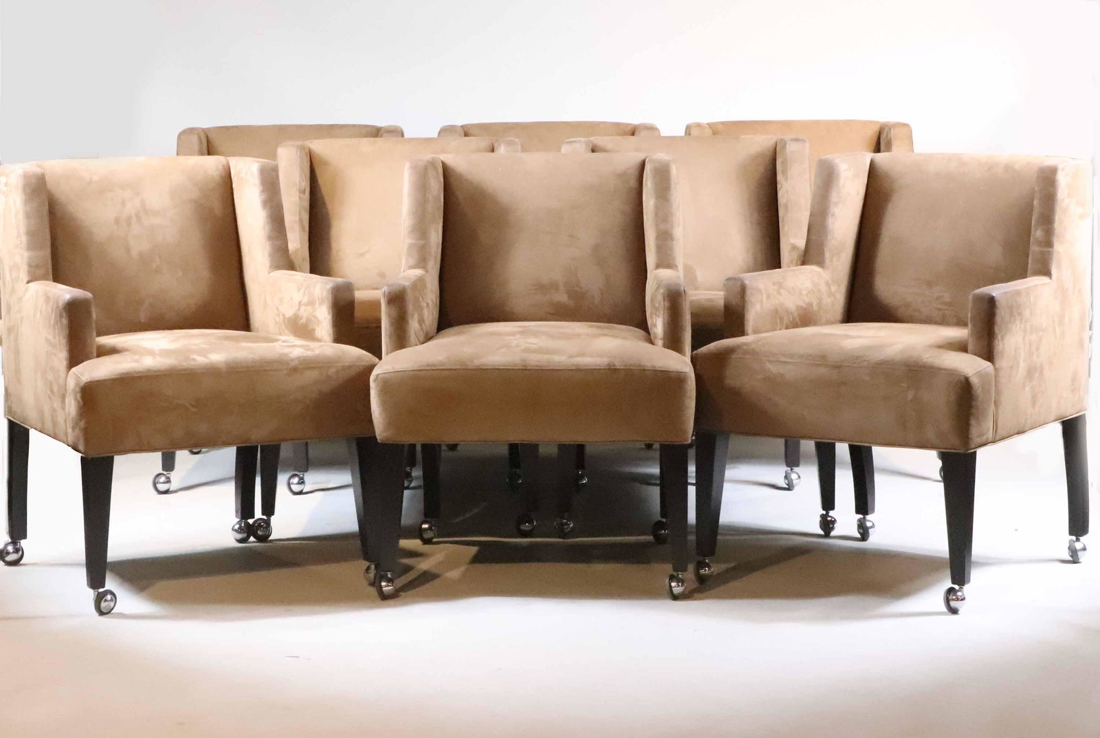 Eight Brown Suede Upholstered Armchairs: 20th C. on casters. Some wear, surface distress, stains. 33-1/2"h x 24"w x 27"d