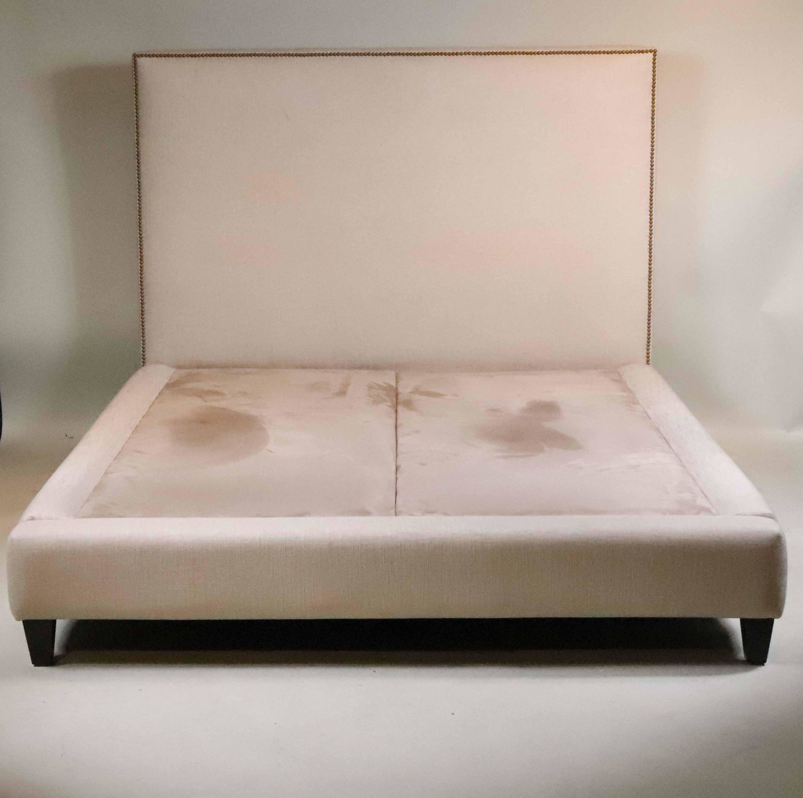 Contemporary Beige-Upholstered Bedstead: 20th C. with brass-tacks. 4'1-1/4"h x 5'2"w x 7'2"l
