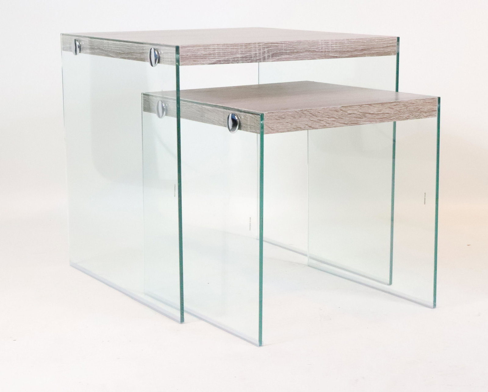 Pair of Monarch Laminate and Glass Nesting Tables: 20th C. wood laminate. 20"h x 19-3/4"w x 20"d