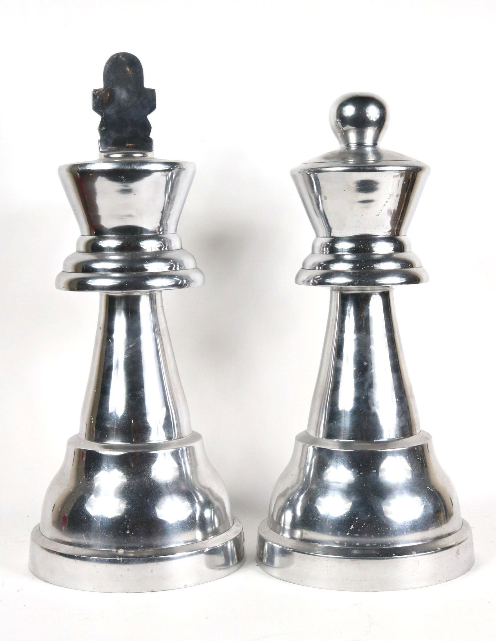 Pair of Polished Aluminum Oversized Chess Pieces: Comprising a King and Queen. 23"h x 10"dia.