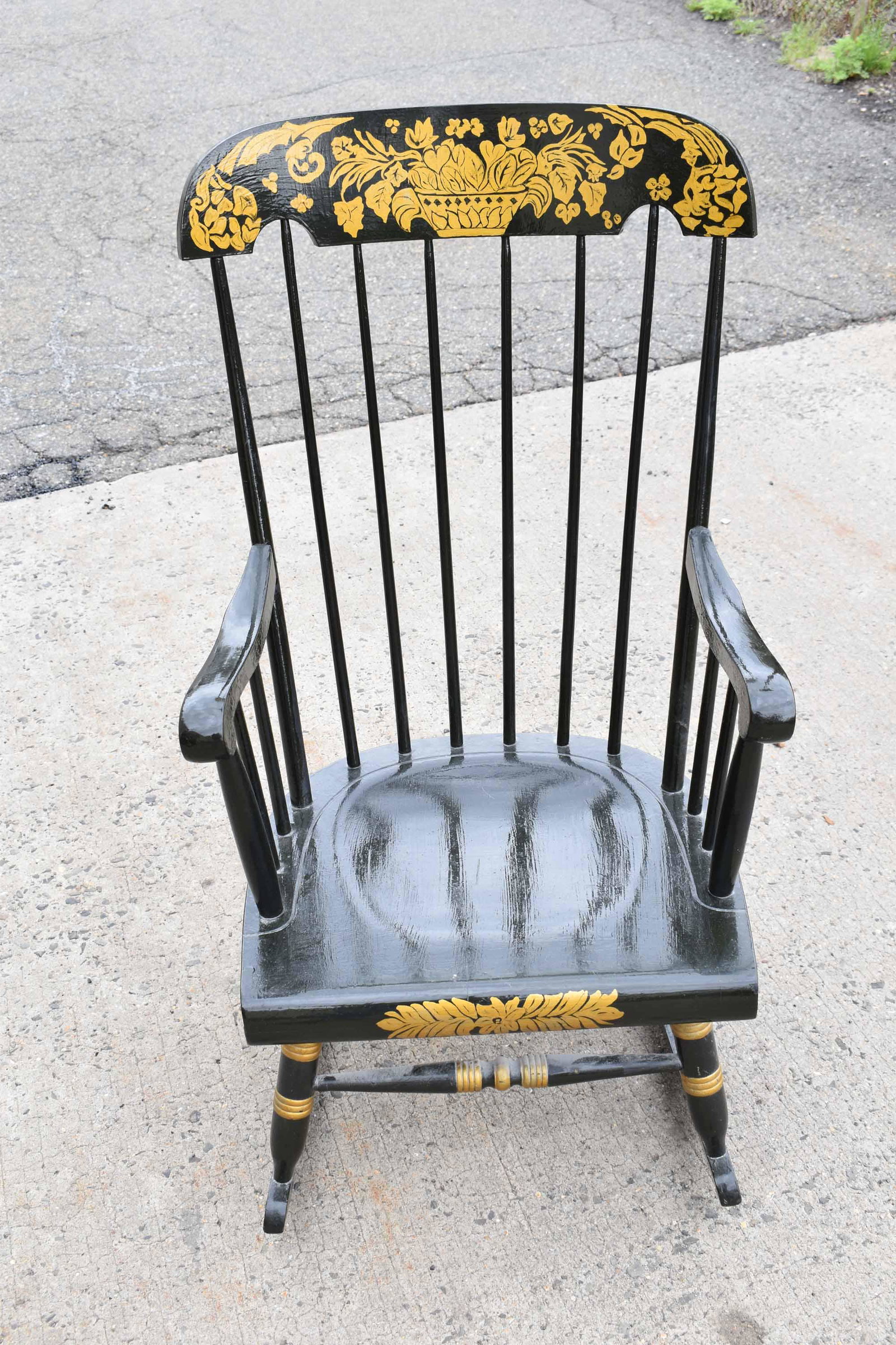 Black Stenciled Rocking Chair: Black Stenciled Rocking Chair with gold accents; used condition, wear/worn, paint loss, measures 41" high x 20" wide x 29" deep