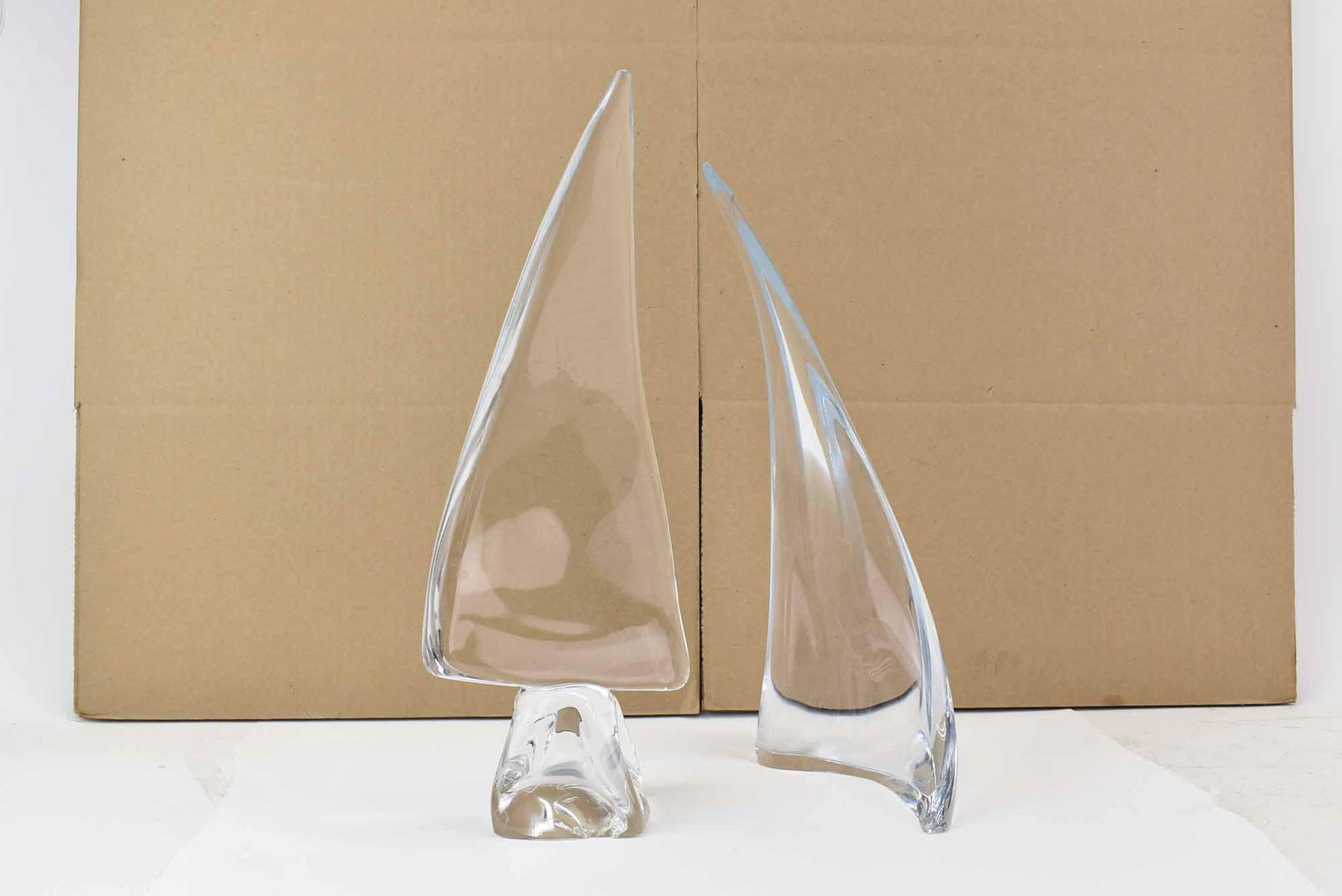Daum France Crystal Sailboat Art Sculpture: Daum France Crystal Sailboat Sculpture together with a Marcolin Sweden Crystal Sailboat or Wave; used condition, wear/worn, both have a large chip to base, Daum is missing all but the D of the signatu