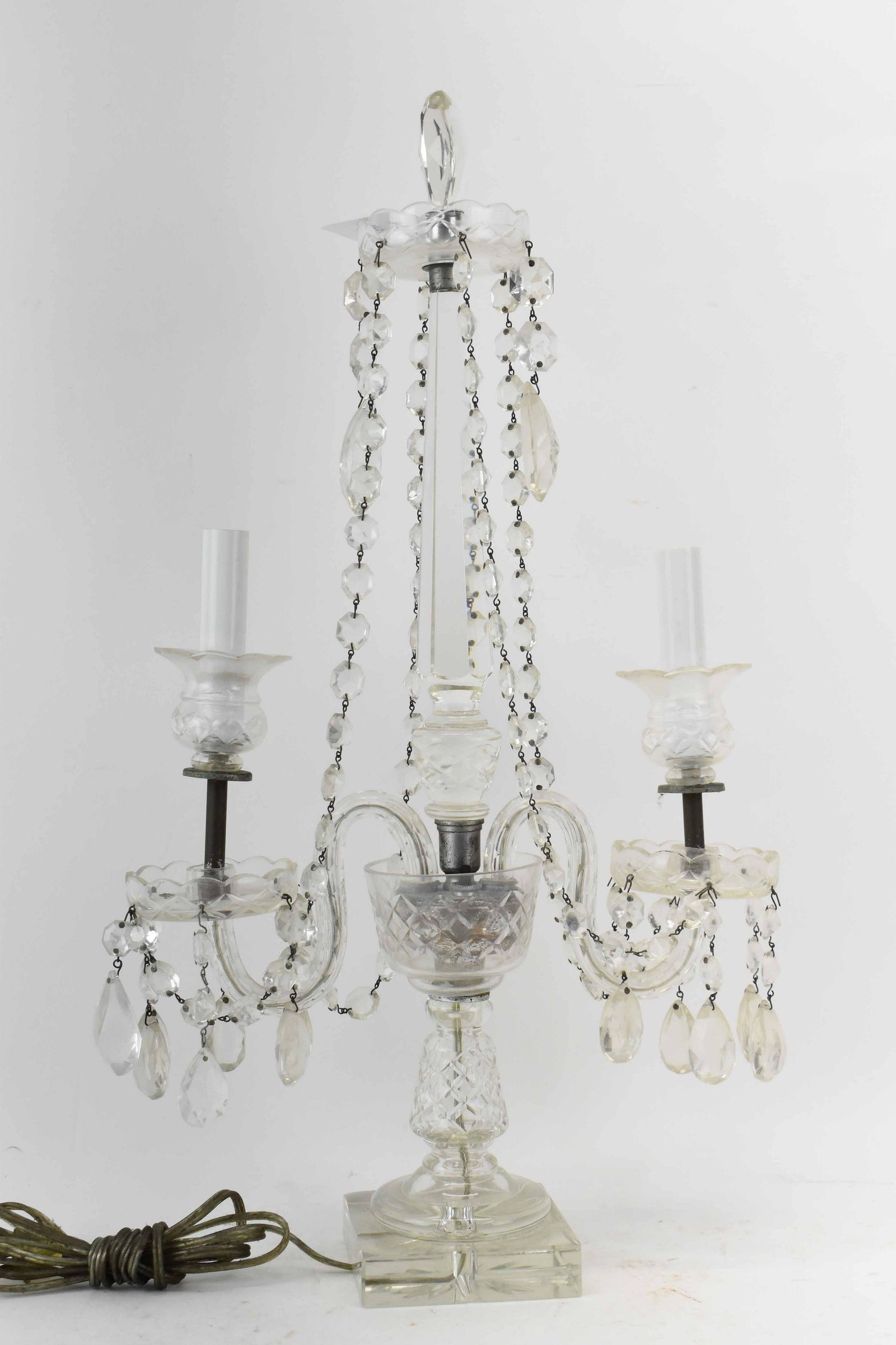 Crystal 2-Arm Candelabra: Crystal 2-Arm Candelabra with cut and strung crystals, has been electrified; used condition, wear/worn, chips, unknown working condition, measures 22" high, 12 1/4" long x 4" wide