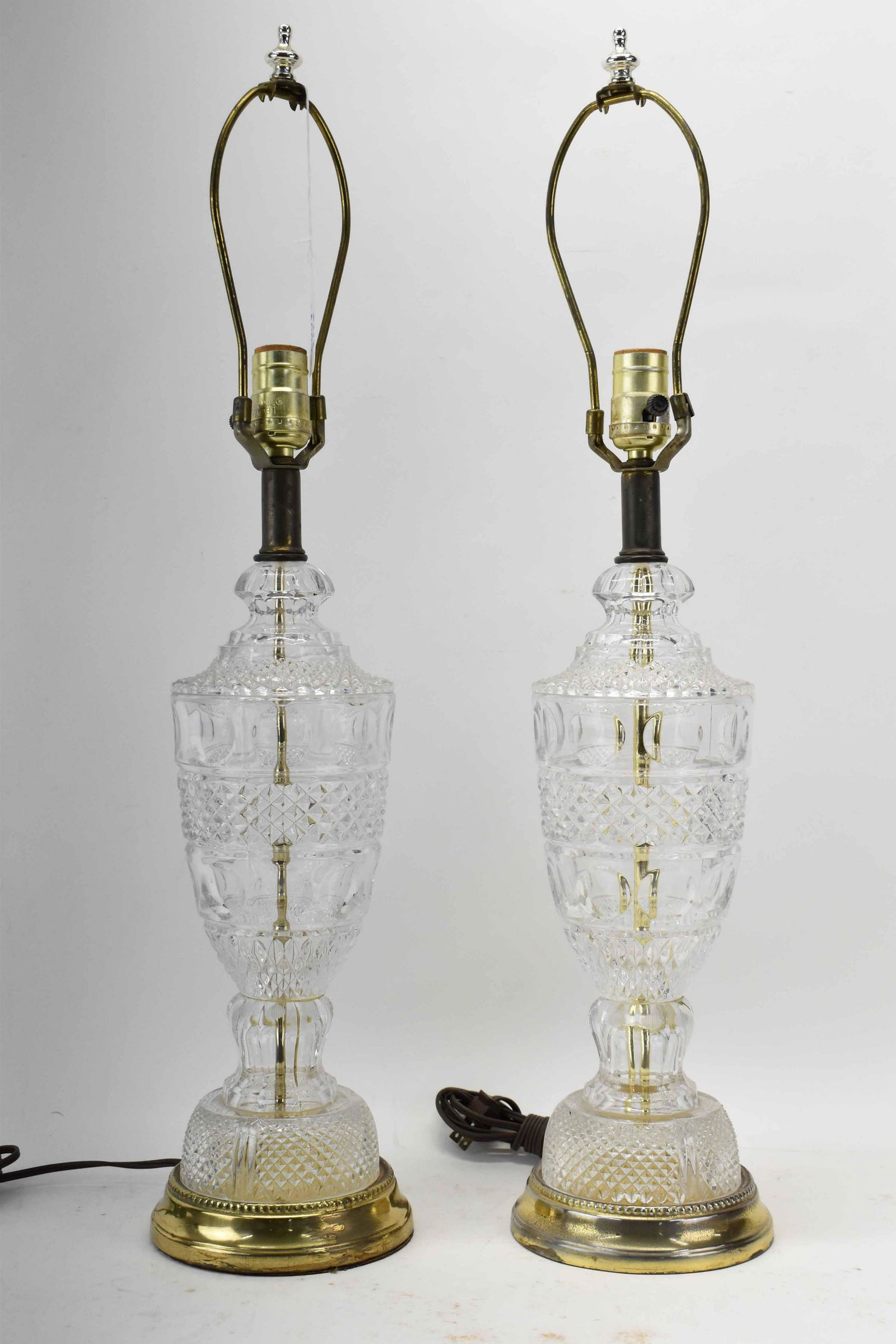 Pair of Pressed Glass Table Lamps: Pair of Pressed Glass Table Lamps mounted on brass bases; used condition, wear/worn, tarnish to brass, unknown working condition, measures 27 1/2" high x 6" in dia.