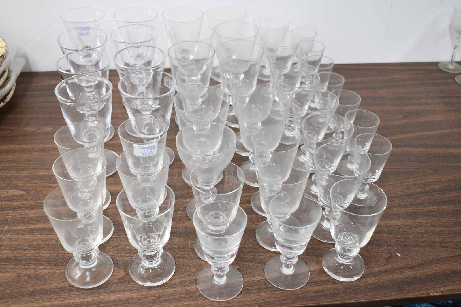 8 Simon Pearce Water Goblets: 8 Simon Pearce Water Goblets having square shaped bowls (free of chips/cracks), together with an assembled set of similar glassware including water goblets, wine and liquor; used condition, wear/worn,