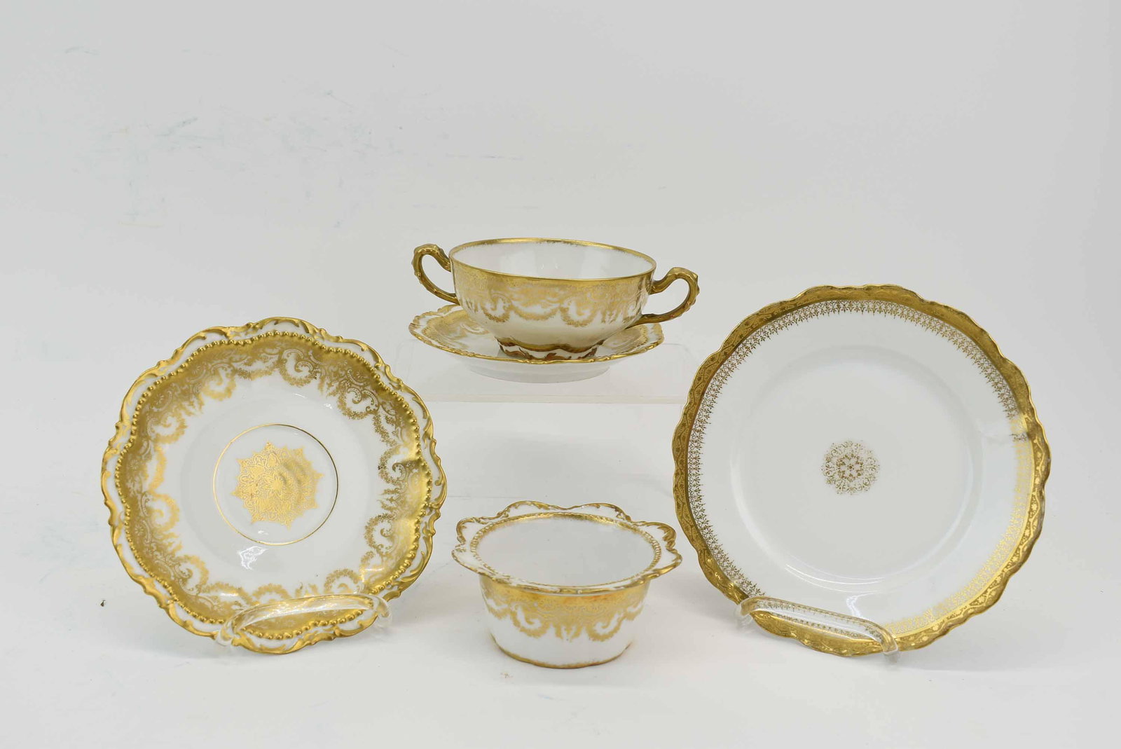 Antique Comte d'Artois Limoges Bouillon Sets: Antique Comte d'Artois Limoges Bouillon Cups & Saucer Sets having hand-painted gold scrolls with beaded and scalloped edge, includes 9 cups (1 with hairline) and 11 saucers, together with a set of Ant