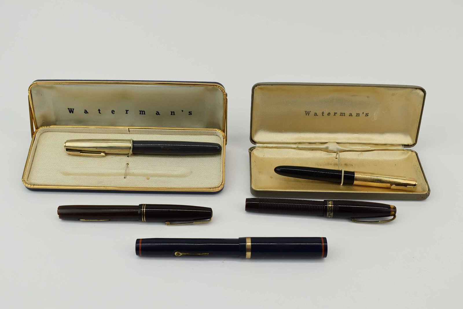 Group of Assorted Waterman's Fountain Pens: Group of Assorted Waterman's Fountain Pens, blue pen nib reads Waterman's IDEAL 14KT, burgundy ribbed nib reads Waterman's IDEAL RIGID 14KT 17, burgundy smooth nib reads Waterman's Hundred Year's (bre