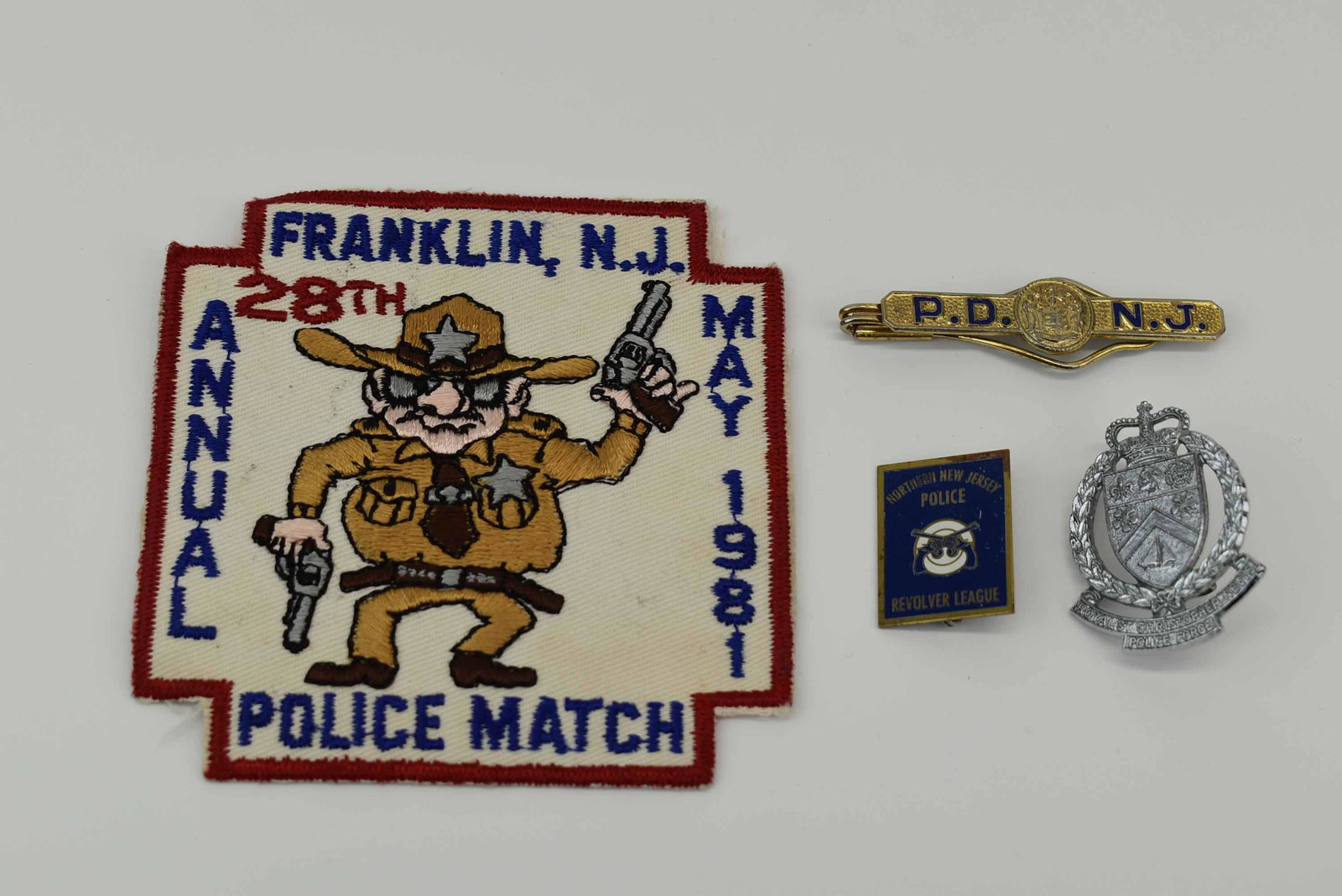Franklin NJ 28TH Annual Police Match 1981 Patch: Franklin NJ 28TH Annual Police Match 1981 Patch. Together with a P.D.N.J. Money clip, Royal ST. Christopher Nevis Police force badge and a Northern New Jersey Police revolver league pin. Used conditio