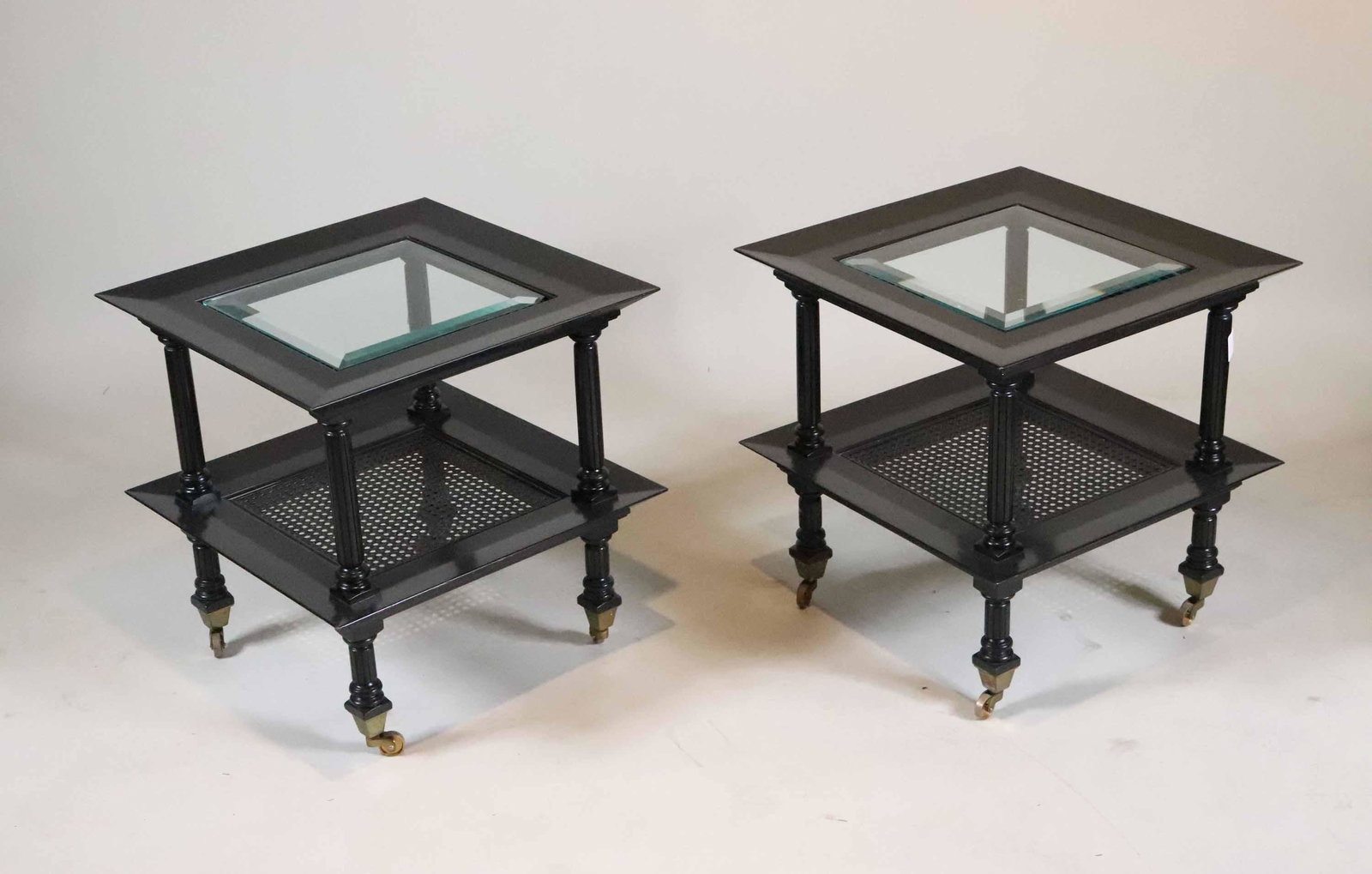 Pair of Ebonized Glass and Cane Inset Side Tables: 20th C. on casters. Chips and losses to glass top. 20-1/4"h x 20"sq. Property from a Short Hills, NJ and San Francisco, CA Private Collection