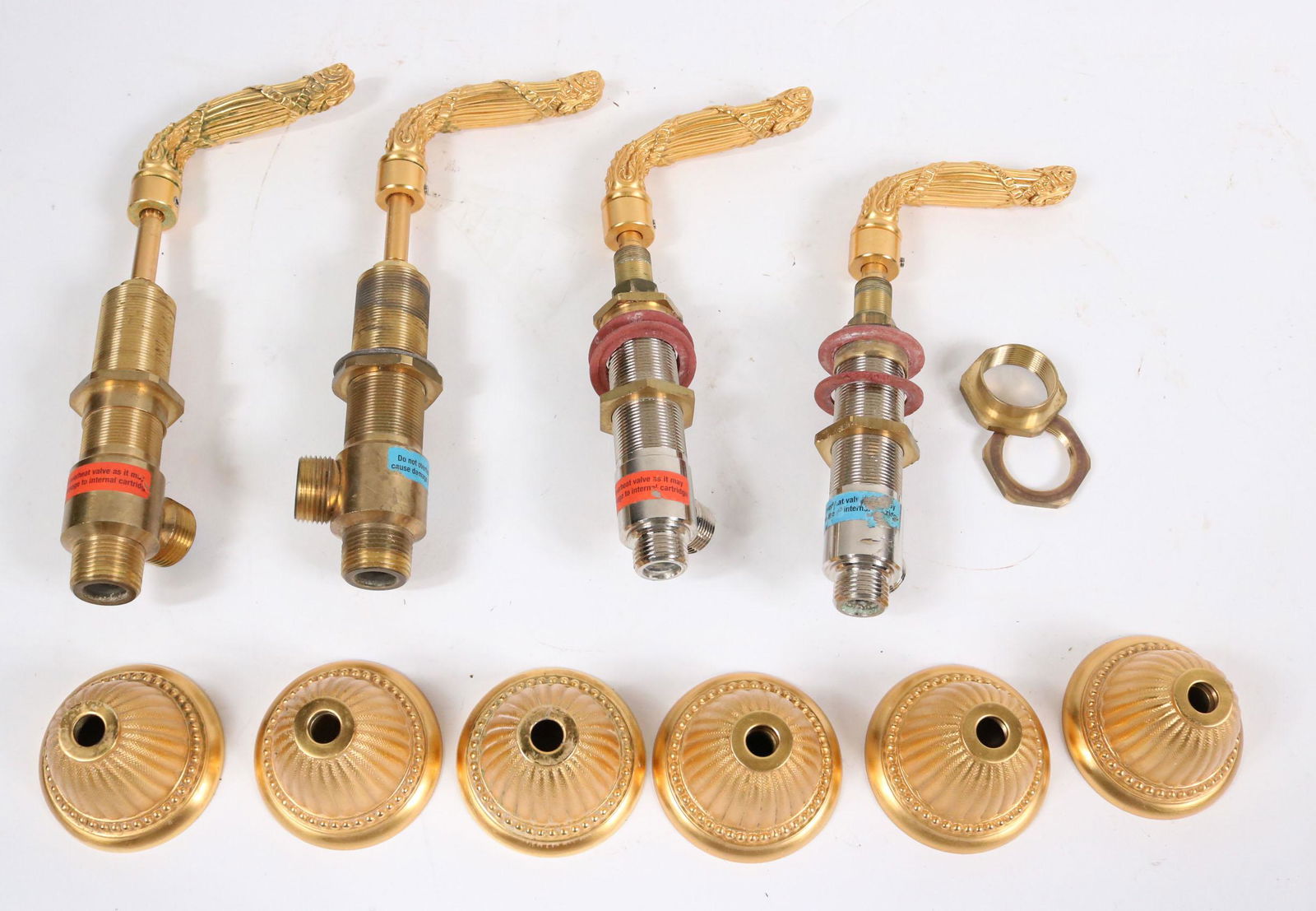 Two Sherle Wagner Louis Seize Faucet Levers: Together with six Sherle Wagner Louis Seize faucet escutcheons. Escutcheons: 2-3/4"dia. x 2"h Levers: 2-3/4"h x 4"w