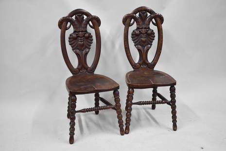 Pair of Michigan Chair Co Oak Satyr Carved Chairs: Pair of Michigan Chair Co Oak Satyr Carved Chairs. Used condition, some wear, loose back. 39 3/4" tall x 16 1/2" wide x 19" deep and 17 3/4" tall to top of seat.