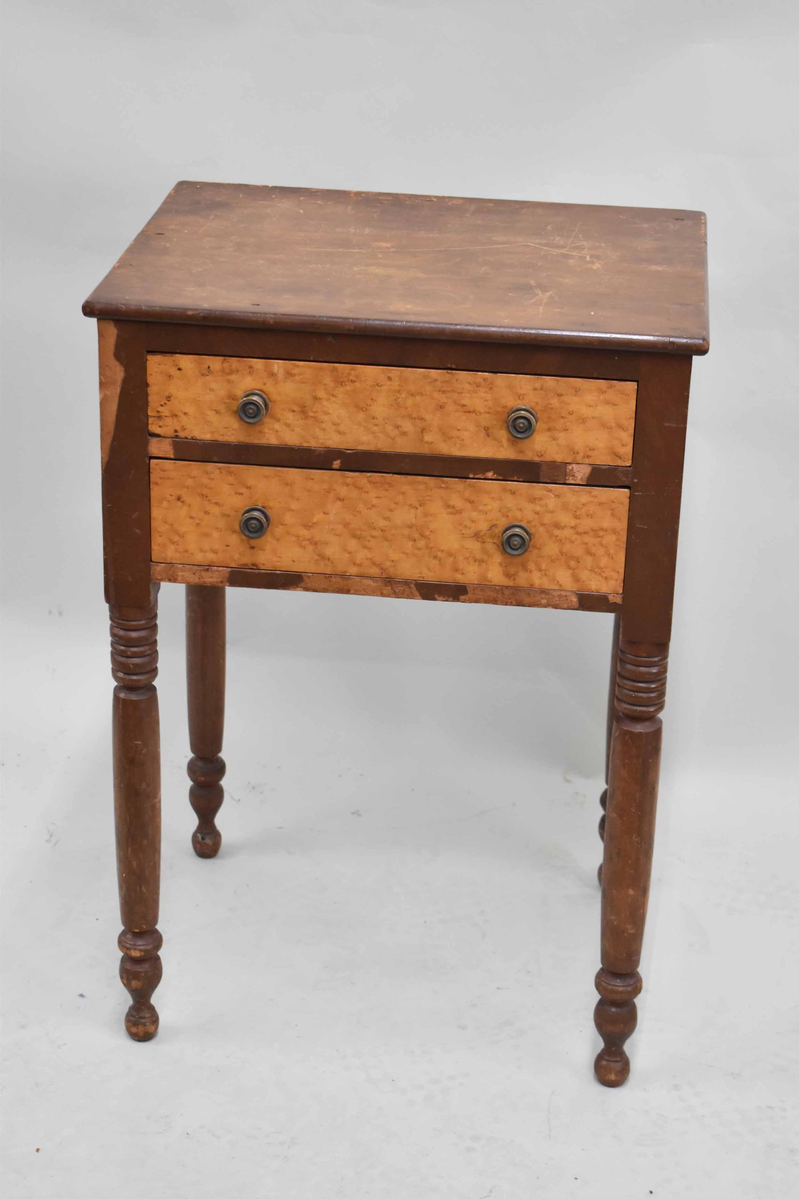 2-Drawer Work Table With Birdseye Maple Veneer: 2-Drawer Work Table With Birdseye Maple Veneer having a solid top, brass knobs, dovetailed drawers, and a partitioned top drawer. Measures approximately 21" x 16 1/2" x 30" tall. Used condition, wear/