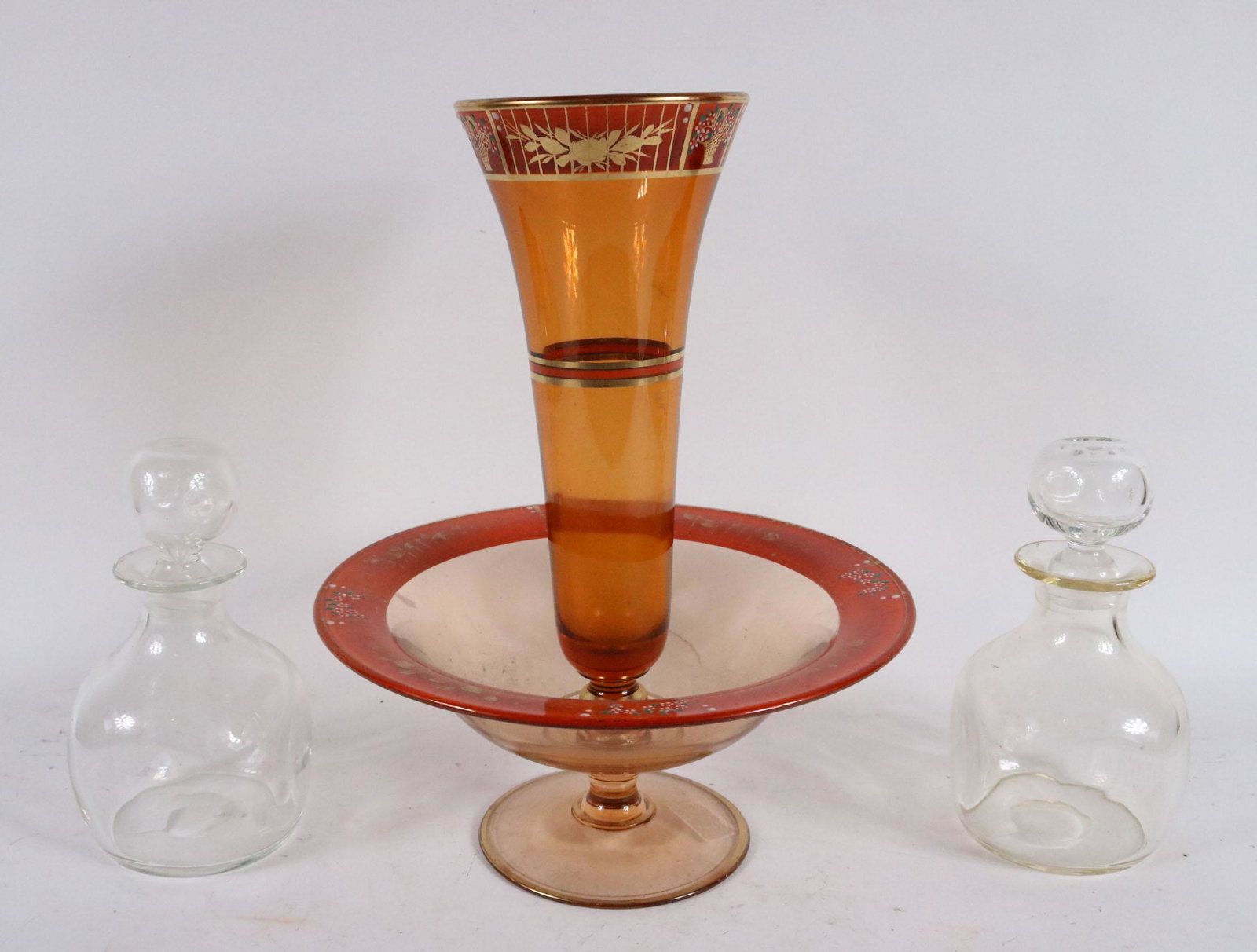 Painted and Parcel-Gilt Amber Glass Epergne: Together with a pair of colorless crystal decanters, unmarked. 15-1/2"h x 12-1/4"dia. And 9"h x 5"w