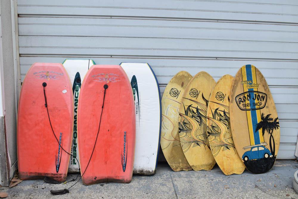 Group of Skimboards and Boogie Boards: Group of skimboards and boogie boards. Including Morey, Ron Jon Surf Shop and Slick Lizard. Used condition, wear, worn, unknown working condition.