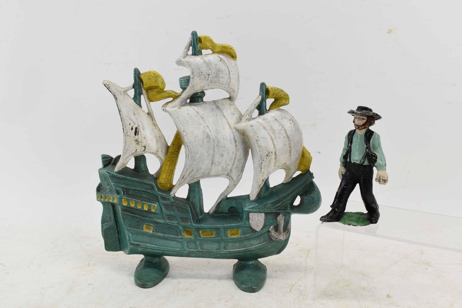 Vintage Cast Iron Galleon Door Stop: Vintage Cast Iron Galleon Door Stop, c. 1930, painted in the form of a galleon in full sail, back is stamped 403 Copyright 1930 Creations Co., together with a cast iron Amish Man Figure; used conditio
