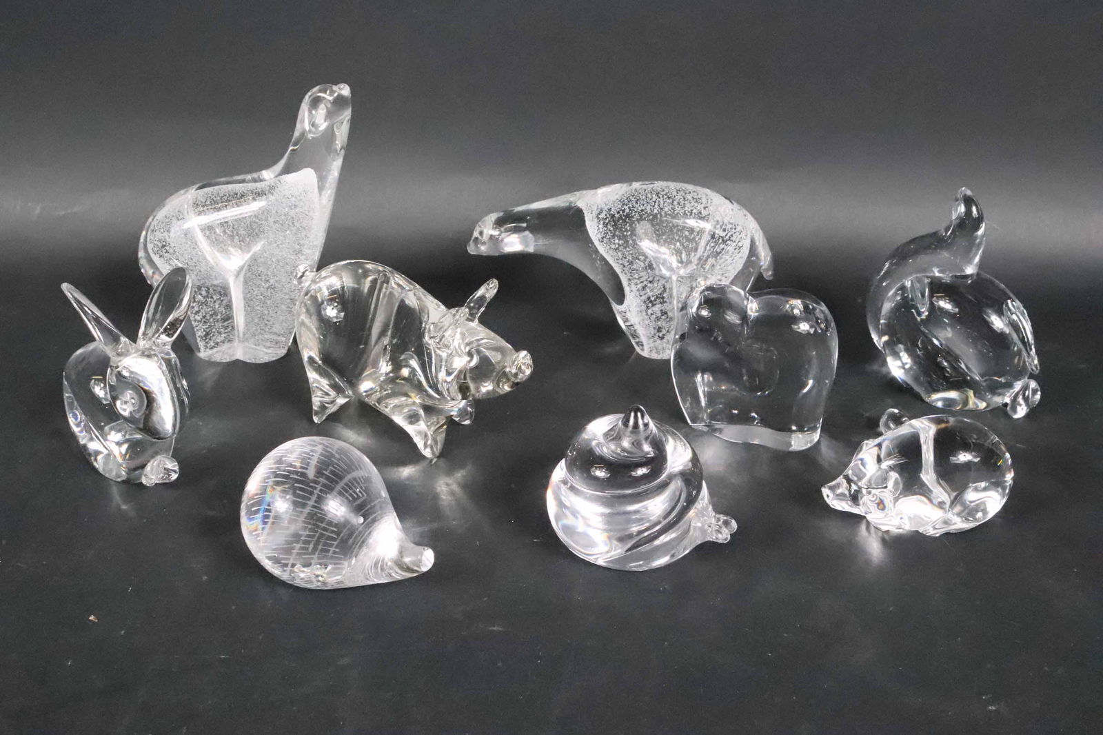 Nine Glass and Crystal Animal Figurines: Comprising, two polar bears, a Baccarat elephant, a Kosta Boda snail, a Kosta Boda hedgehog, a squirrel, a pig, a Steuben pig, and a rabbit. Losses, chips, scratches.