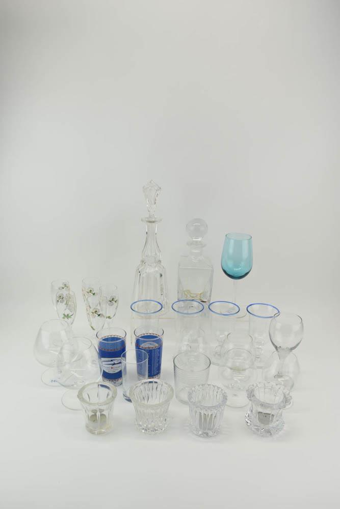 Group of Assorted Colorless Glass Barware: Group of Assorted Colorless Glass Barware comprising 4 Lindean Mill (Scotland) goblets with blue rim, 2 painted Kentucky Derby 2010 highball glasses, 2 decanters, 4 votive candle holders, 6 brandy sni