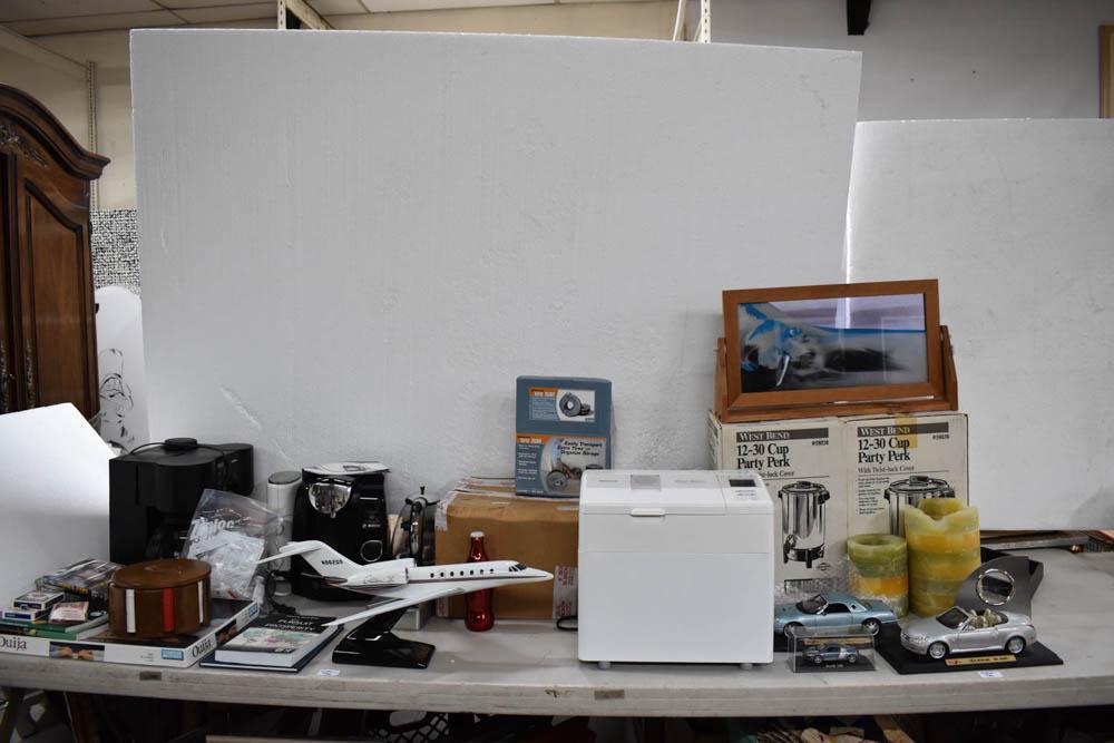 Group of Assorted Kitchen and Table Articles: Group of Assorted Kitchen and Table Articles including espresso machine, bread machine, coffee makers, framed moving sand art, poker set, candles, case of new Seasonal Tire Totes, model cars 2002 Thun