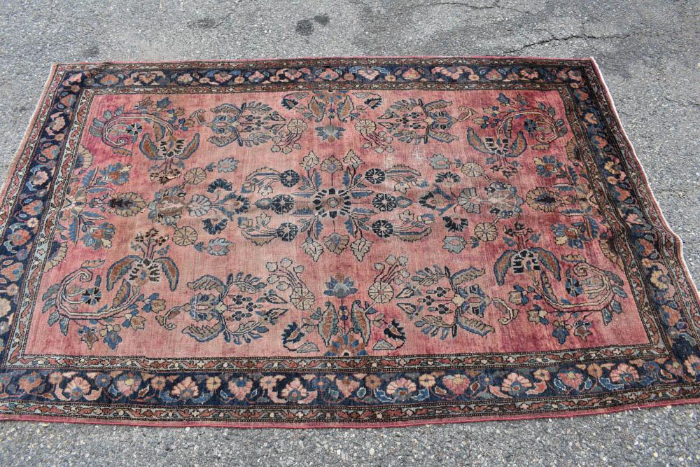 Sarouk Area Rug: Sarouk Area Rug having central red ground with all over floral and foliate design. Used condition, wear, worn. 4'2" x 6'6"