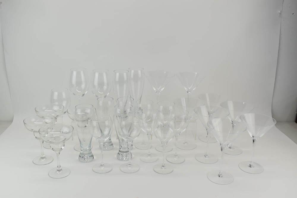 Group of Assorted Colorless Glass Stemware: Group of Assorted Colorless Glass Stemware (28 pieces total) Includes red wine glasses, white wine glasses, beer glasses, margarita glasses, martini glassed Used condition, wear/worn