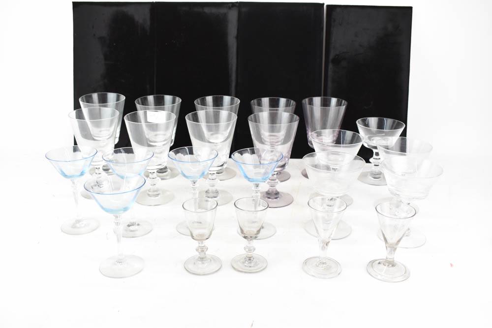 Group of Assorted Colorless Glass Stemware: Group of Assorted Colorless Glass Stemware together with a set of 5 blue wine glasses and 3 violet colored goblets. Used condition, wear, worn.