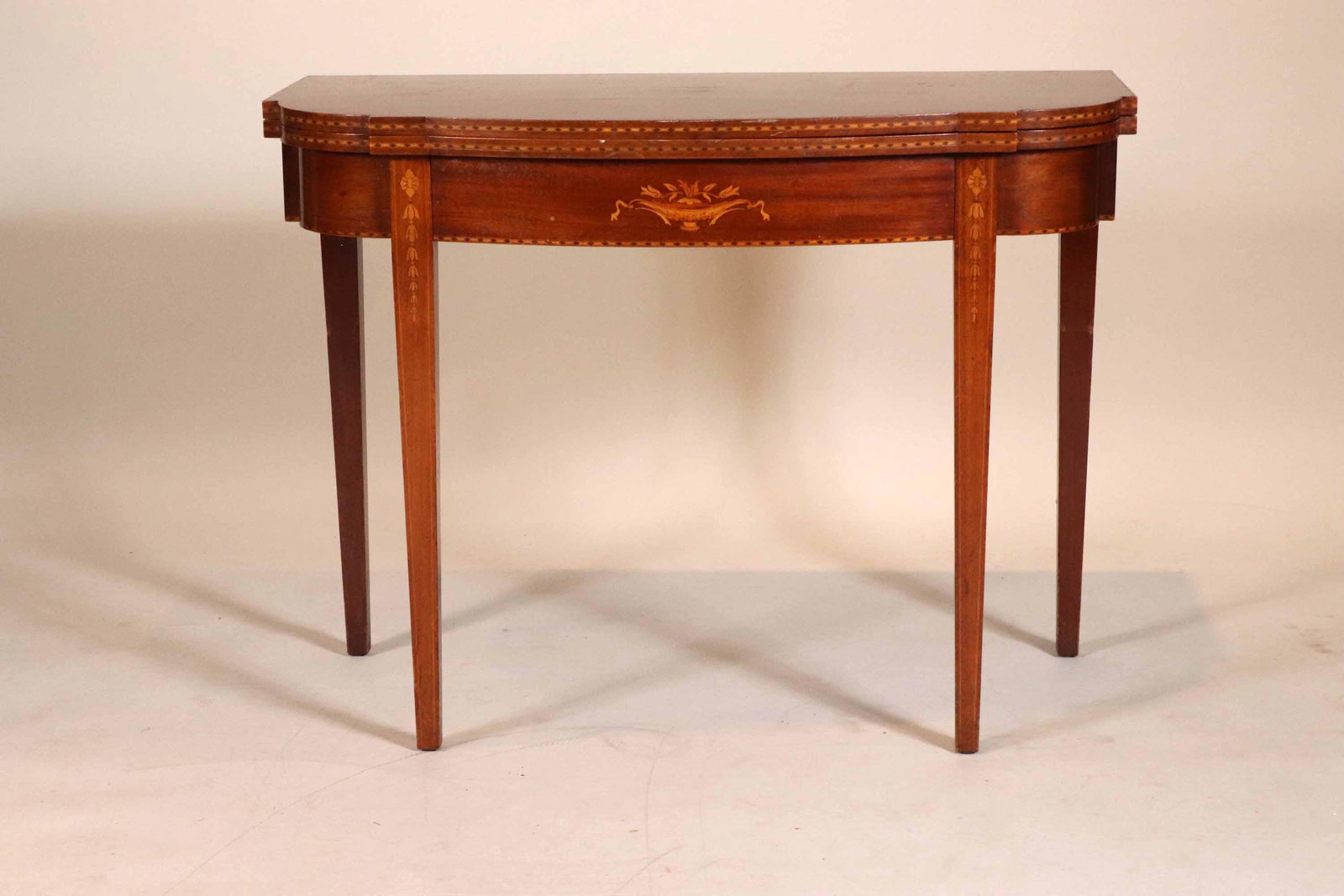Federal Style Inlaid Mahogany Games Table: American Taste, early 20th C., extending 30"h x 40"w x 20"d (closed) Provenance: Property from a New York City Gentleman