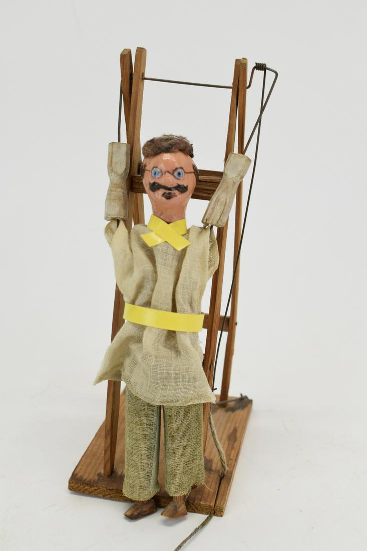 Folk Art Action Toy of Man Climbing Ladder: Folk Art Action Toy of Man Climbing Ladder Used condition, wear/worn, staining to base, paper belt and tie replaced Measures approximately 9" tall x 3" x 5"