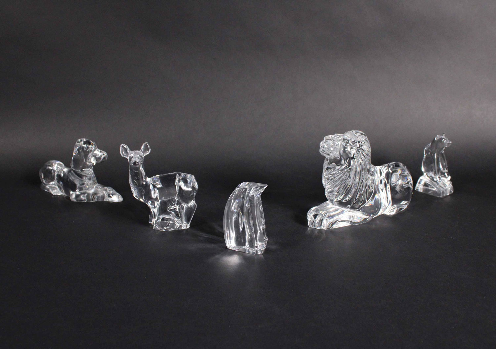 Waterford Crystal Lion: Marked "Waterford" along side body, together with four other animal figurines from various makers including Hadeland, 5 pieces total Lion: 4-1/2"h x 2-1/2"w x 6"d Provenance: Property from a Private N