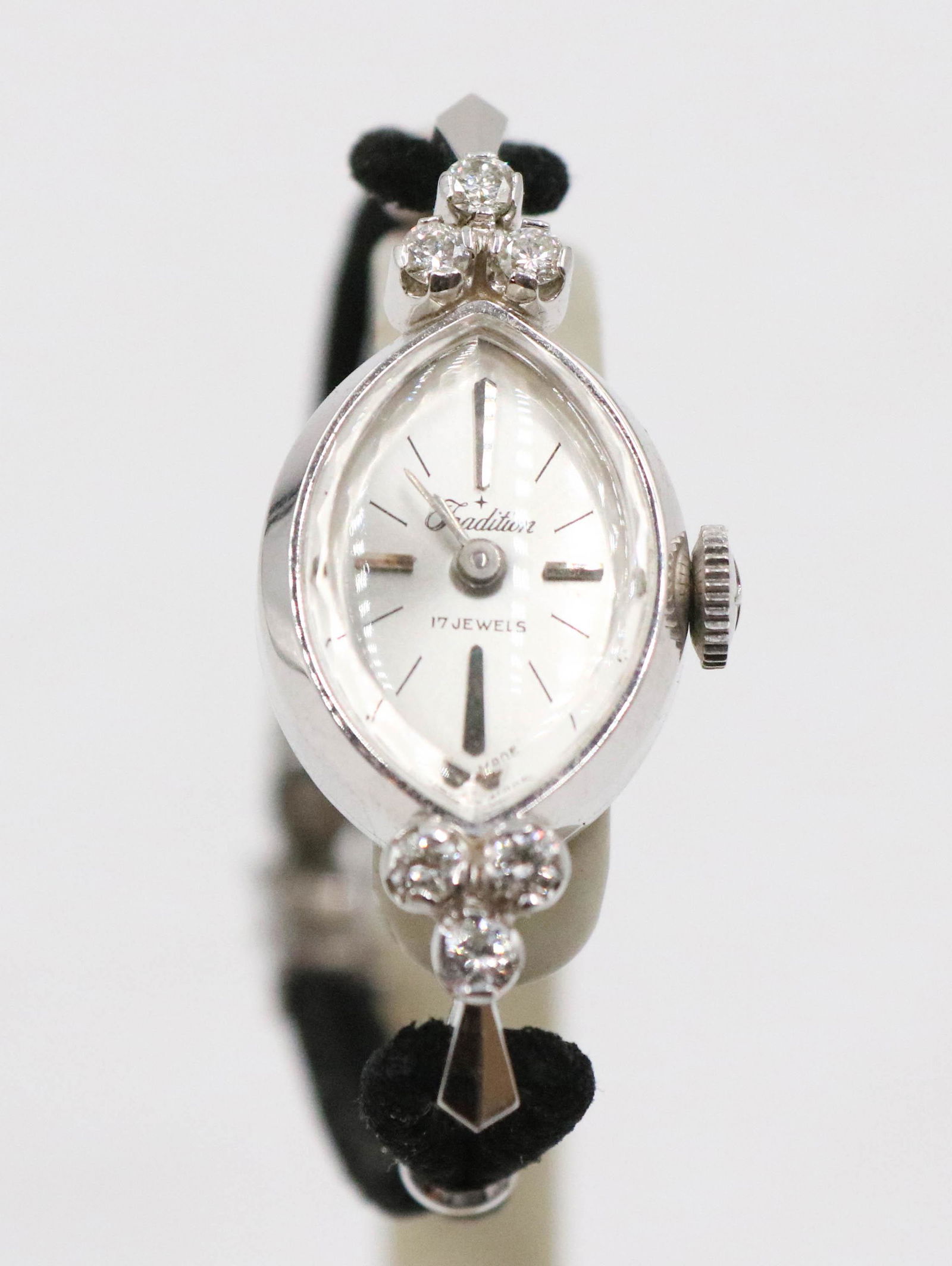 Vintage Ladies Tradition 14K White Gold Watch: Vintage Ladies Tradition 14K White Gold Watch, comes with a pink Tradition box. Watch is oval shaped and is currently running but has not been tested in any manner. Watch has a gold filled watch band