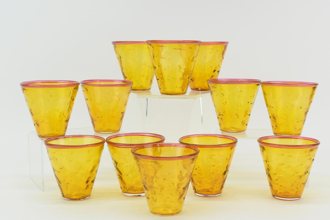 Twelve Rossi Thomas Art Glass Scotch Glasses: Twelve Rossi Thomas Art Glass Scotch Glasses having amber glass with cranberry glass rim. Each signed at bottom and dated 2003. Used condition