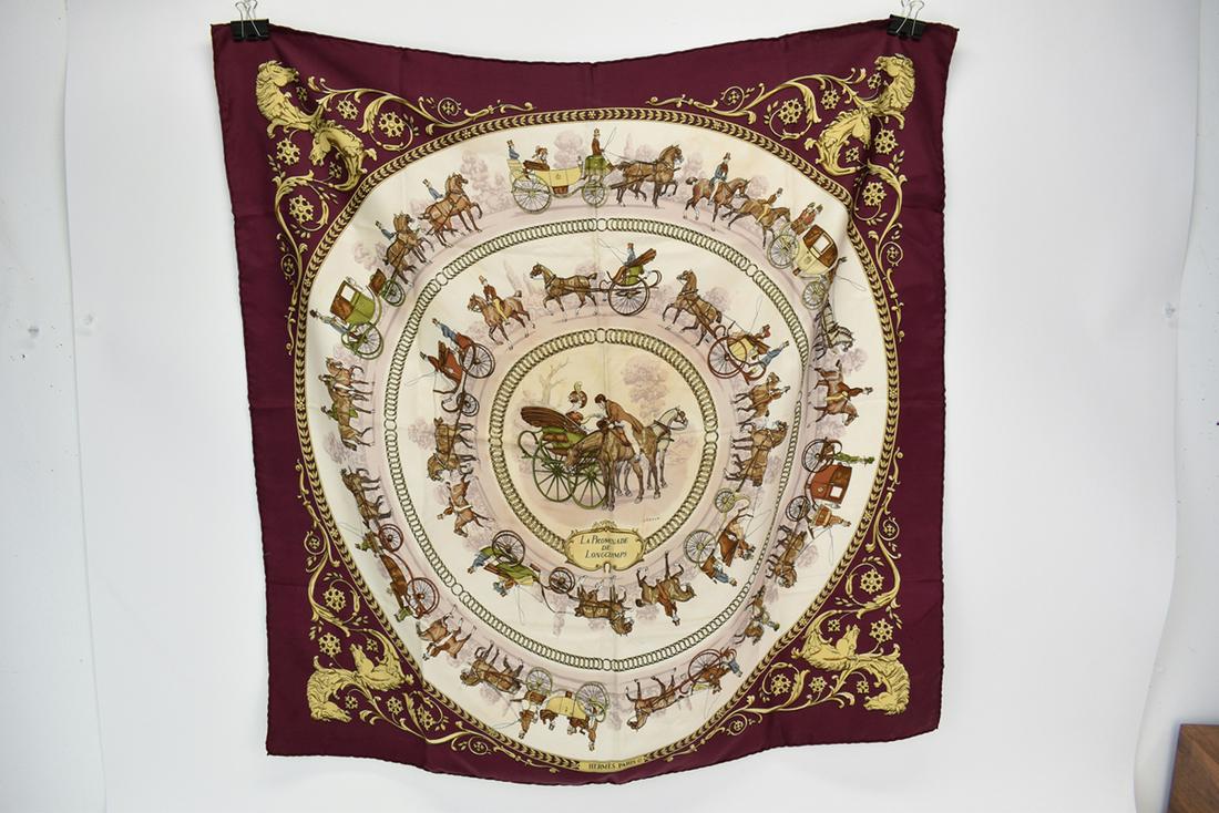 Hermes Silk Scarf La Promenade de Longchamps: Hermes Silk Scarf La Promenade de Longchamps by artist Ledoux depicting horse-drawn carriages and ornate gold scrolling having and-rolled edges Used condition, stains Appx. 34-1/2" x 35"