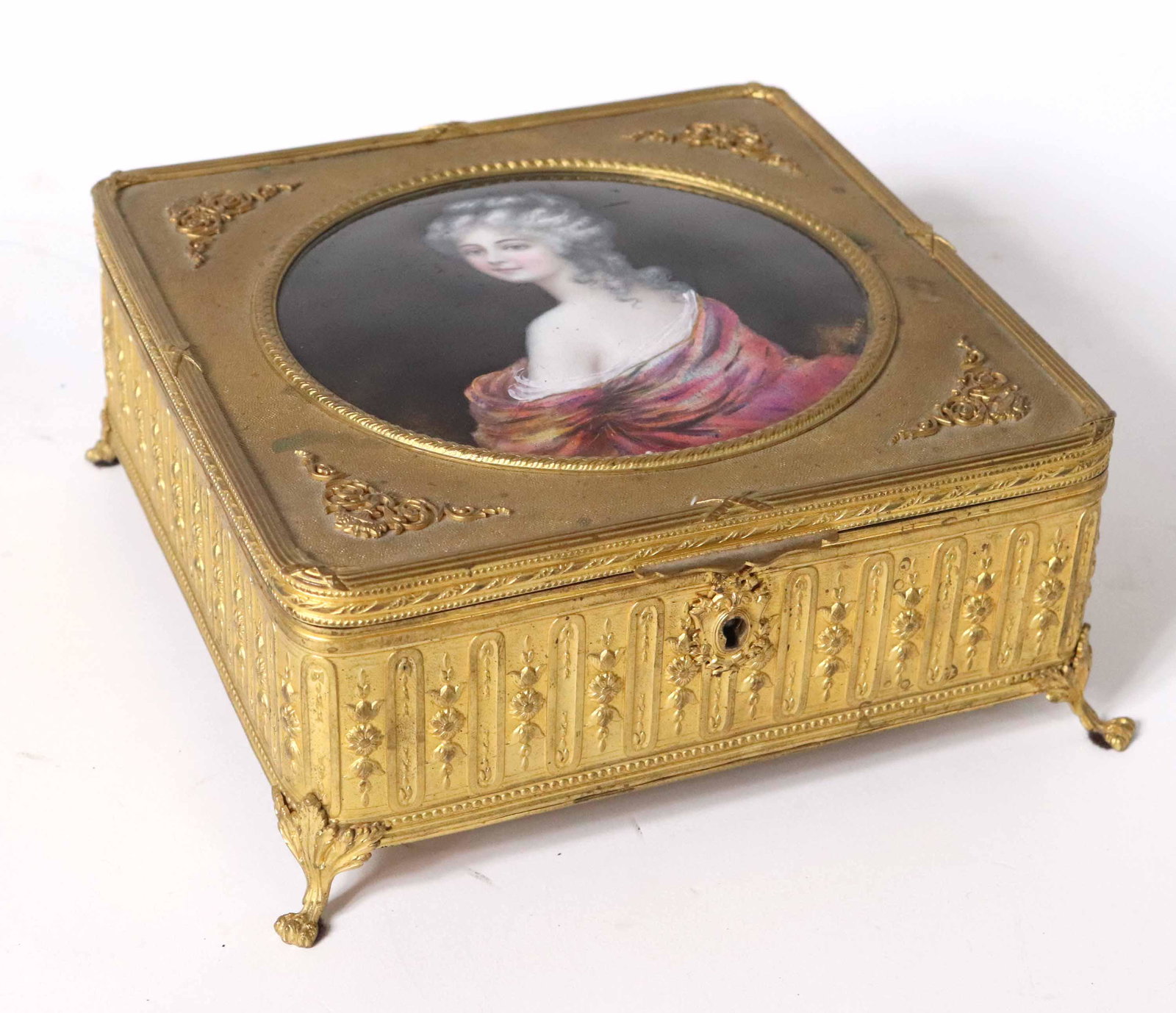 French Enamel Inset Gilt-Metal Casket: 19th/20th C. Inset with enamel portrait of a woman, signed Borval, interior lined with fabric Scratches and wear 3"h x 7-1/2"w x 7-1/2"d