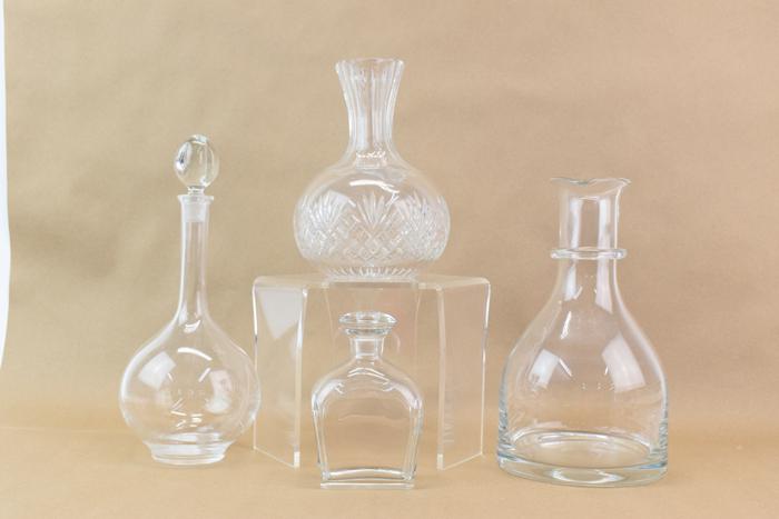 Glass Crystal Decanters Steuben & Orrefors: Glass Crystal Decanters Steuben & Orrefors, four altogether, the smallest at 5-1/2"h marked Orrefors in good condition with slight cloudiness, and the tallest at 11-3/8"h signed Steuben with light scr