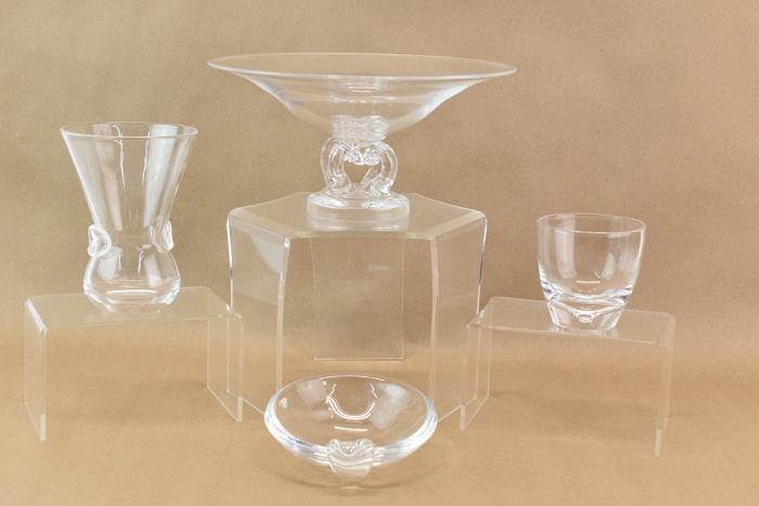 Four Steuben Glass Bowls and Vases: Four Steuben Glass Bowls and Vases, comprised of a 5"h x 10"dia bowl, signed under pedestal base, a 5-3/4"h x 4-1/4"w at top and signed under base vase, a 5-5/8"dia shallow bowl with leaf handle signe