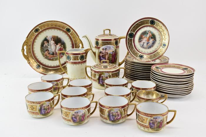 MZ Altrohlau CMR Czechoslovakia Dinner Set: Vintage MZ Altrohlau CMR Czechoslovakia Partial Dinner Set having pictorial central design and gilt and wreath border. Comprising of 11 cups, 12 saucers, 1 demitasse cup, 12 dessert plates, 1 teapot, 