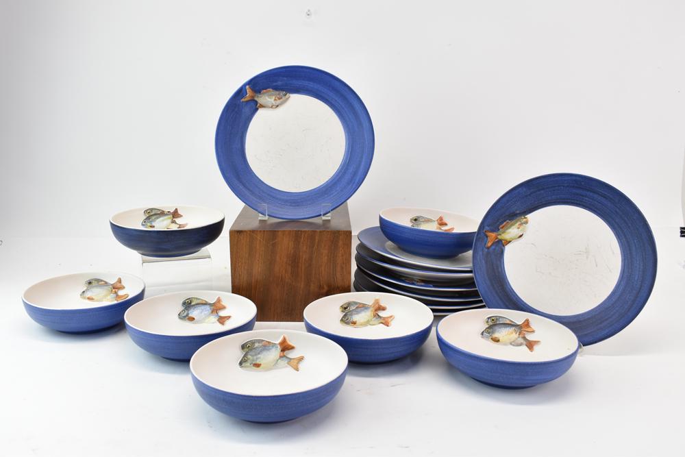 Partial Set of Dominique Guillot Dishware: Partial Set of Dominique Guillot hand painted art pottery Dishware having raised fish design with blue rim. Each having artist signature, hand painted, France, comprising of 8 plates with single fish 
