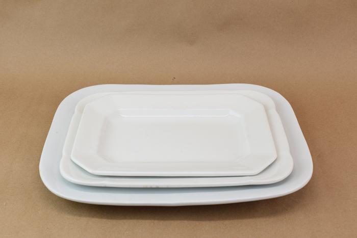Three White Staffordshire Ironstone Platters: Three White Staffordshire Ironstone Platters Used condition with surface wear, some utensil marks, largest example has a rim hairline and what appears to be two made-during-manufacture clay separation
