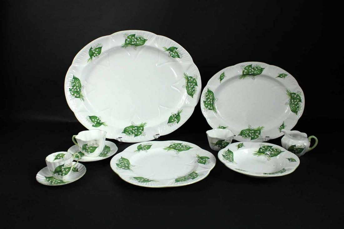 Shelley "Lily of the Valley" Dinnerware: Comprising 8 dinner plates, 8 bowls, 8 teacups and 8 saucers, 8 demitasse cups and 8 saucers, an open sugar bowl, a creamer, and two platters