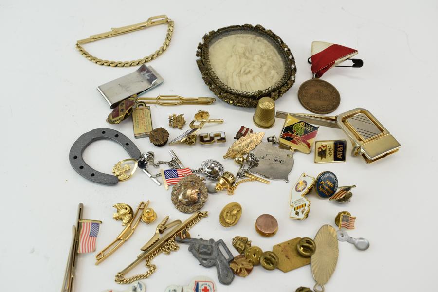 Bas Relief Madonna Plaque & Dresser Items: Bas Relief Madonna Plaque & Assorted Dresser Items comprising several American flag pins, tie clips, Germany stamped thimble, personalized pins and key fobs. Wire rimmed bas relief plaque featuring th