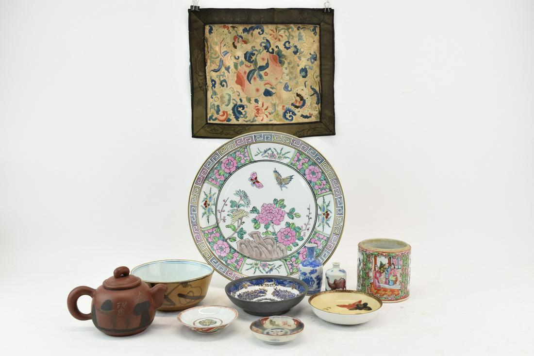 Assorted Asian Tea and Table Articles: Assorted Asian Tea and Table Articles comprising an embriodered mat, several tea bowls, two small bud vases, teapot, charger, and canister with no lid. All items are in used condition, some crazing, a