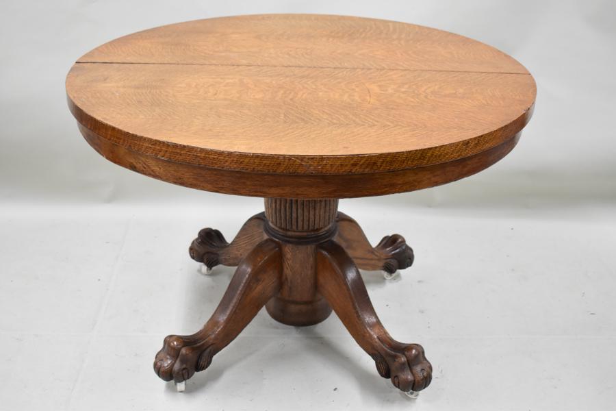 Antique Oak Dining Table: Antique Oak Dining Table having a 44" circular top resting on a pedestal base with claw feet. Together with a set of four oak caned seat side chairs. Used condition, wear, worn.