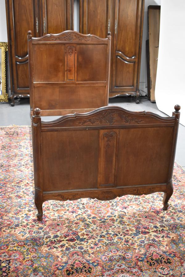Provincial Carved Bed: Provincial Carved Bed with headboard and footboard each having central carvings depicting basket and flowers. Used condition, wear/worn Headboard 46-3/4"h, bed appx. 36"w x 76"l