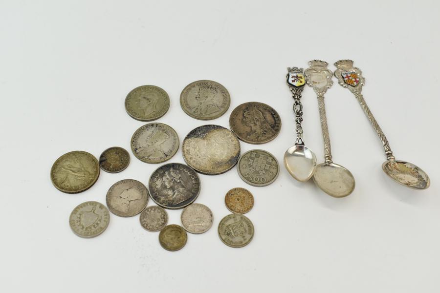 Assortment Antique Currency Coins: Assortment Antique Currency Coins together with three souvenir spoons. Coins represented include an 1890 Victoria, a Cuban silver coin, lire, shilling, and others. Spoons are from the Vatican and Barc